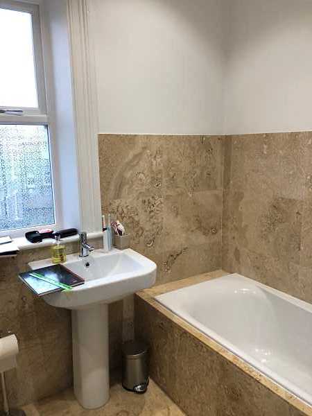 the old bathroom where the bath was replaced by a walk in shower